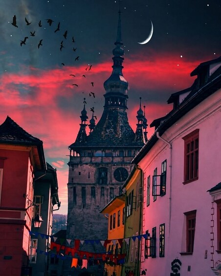 A historic building with a clock tower, colorful buildings, and a crescent moon in the sky. 1