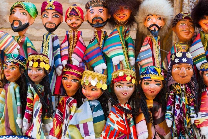 A group of colorful, traditional dolls with intricate clothing and accessories. 5