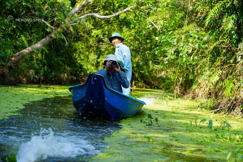A boat on a river surrounded by dense greenery. 1