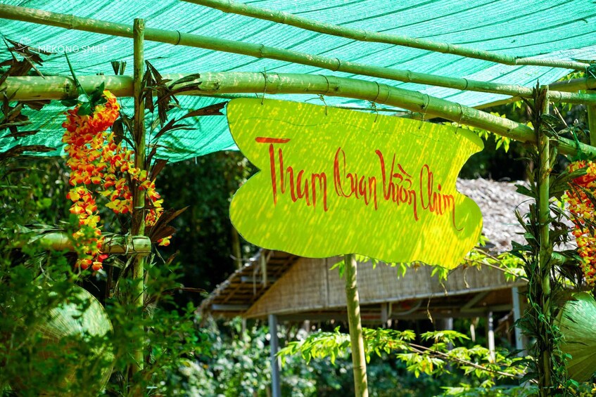 A green netted structure with a yellow sign that reads 'Tham Guan Vi Nam Ninh.' 4