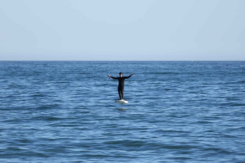 A person surfing on a wave in the ocean. 1