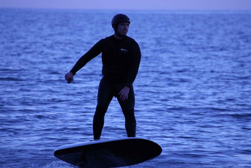 A person surfing on a wave in the ocean. 5