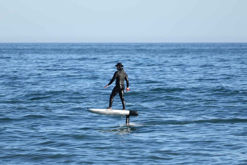 A person surfing on a board in the ocean. 3