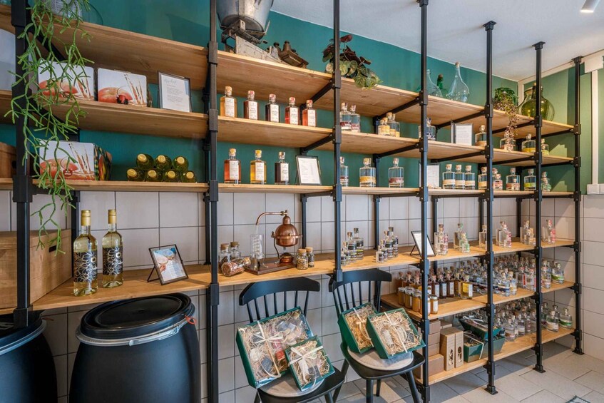 A store with shelves of bottles and jars, some with labels, and a few chairs with packages. 3