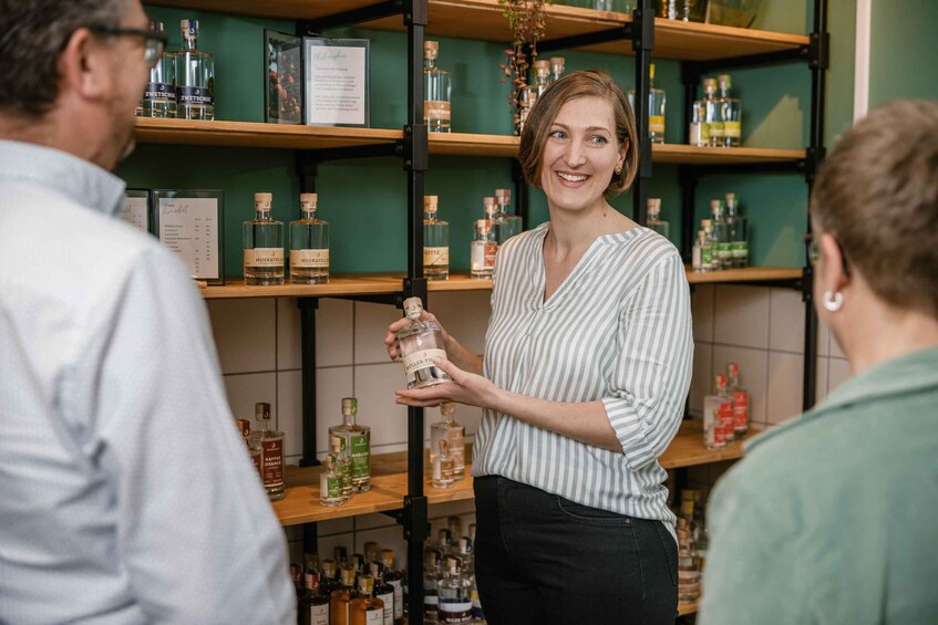 A person holding a bottle in a store with shelves of various bottles. 2