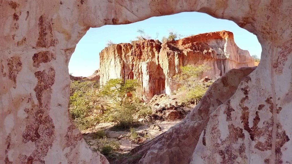 A rock formation with a natural archway. 1