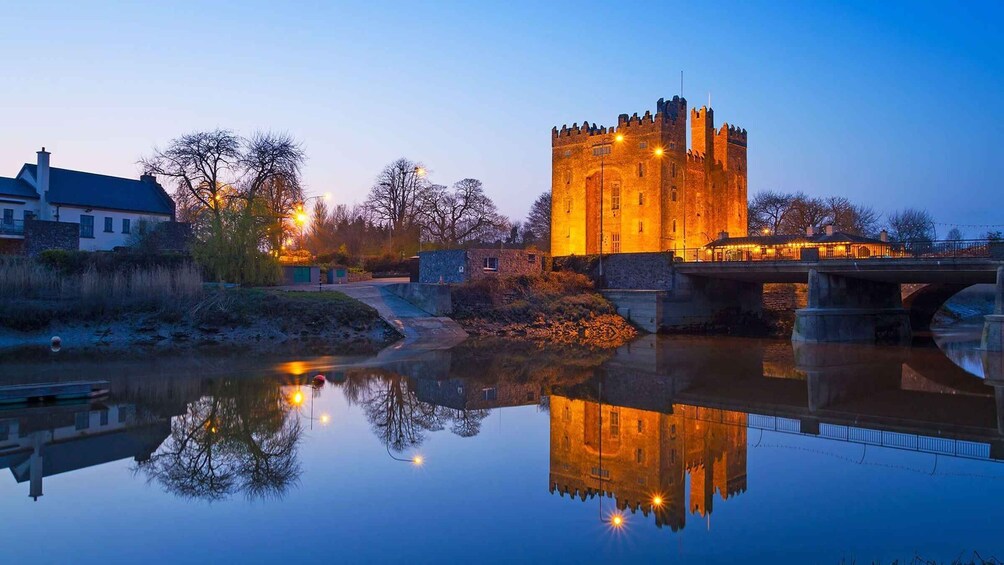 A castle with a moat and a bridge, reflecting in the water. 4