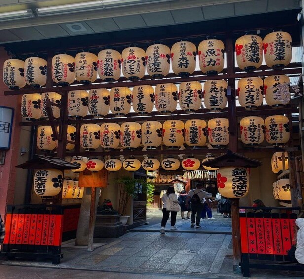 A traditional Japanese street with wooden lanterns and red signage. 5