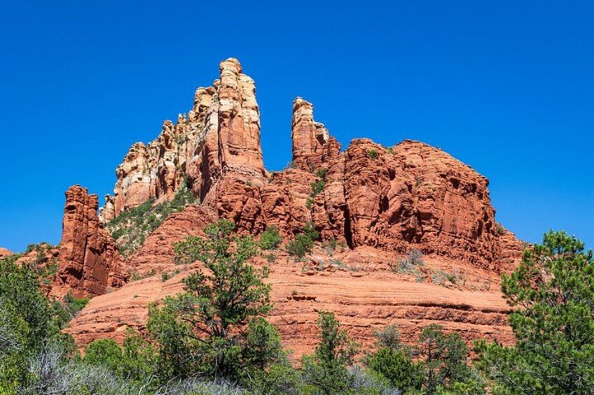 A red rock formation with a clear blue sky. 5