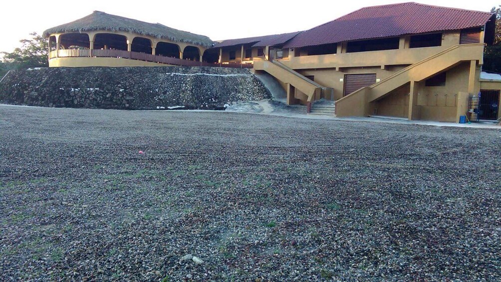 A building with a red roof and a stone wall. 3