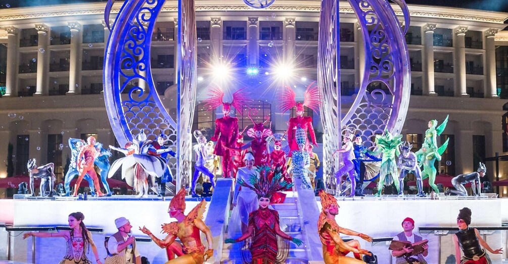 A colorful outdoor performance with dancers in elaborate costumes. 4