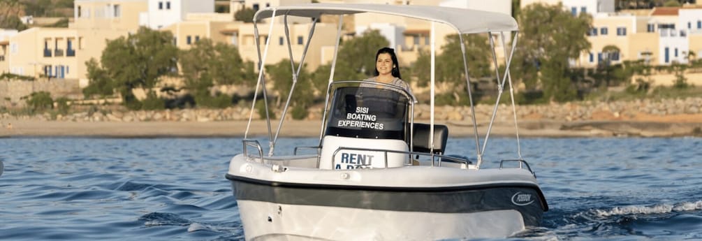 A boat with a 'RENT' sign and 'SISI BOATING EXPERIENCES' on the back. 3