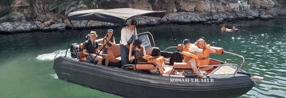 A boat with people wearing life jackets on a calm body of water. 1
