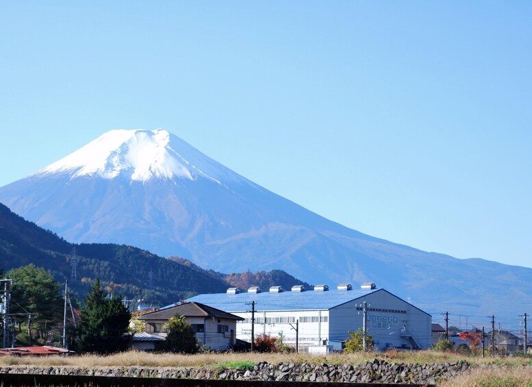 A snow-capped mountain, a building, and a stone wall. 5