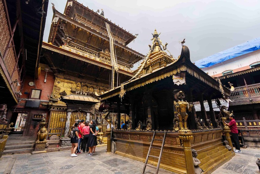 A temple with golden statues and intricate architecture. 5
