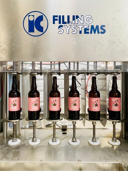 A bottling line with five bottles of Chill Ale being filled. 5