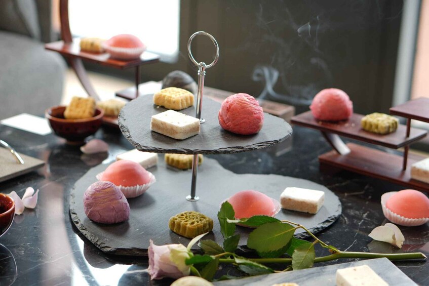 A dessert display with various sweets on a marble table. 3