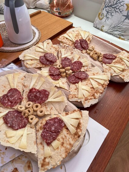 Three pizzas with various toppings on a wooden board. 3