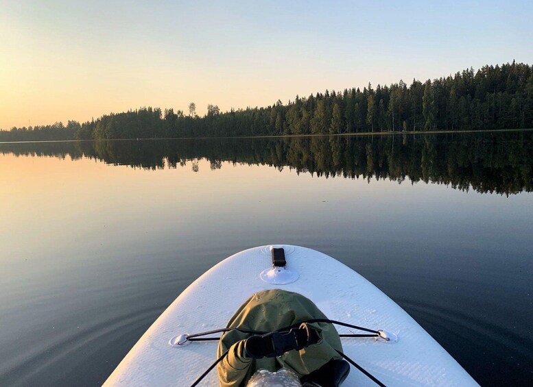 A kayak on calm water with a forest in the background. 3