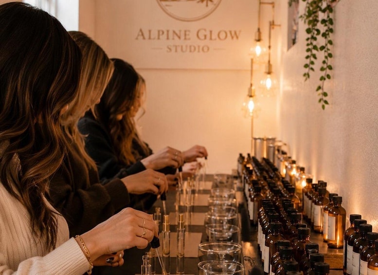 Three individuals at a counter with bottles and glasses, likely for a tasting or sampling event. 3