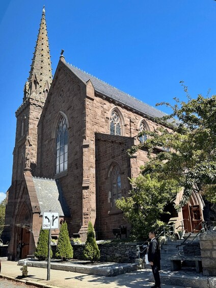 A historic church with a tall spire and arched windows. 3