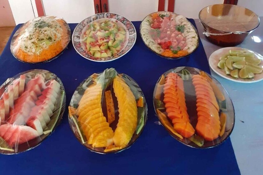 A table with various food items, including wrapped dishes and a bowl of lime slices. 4