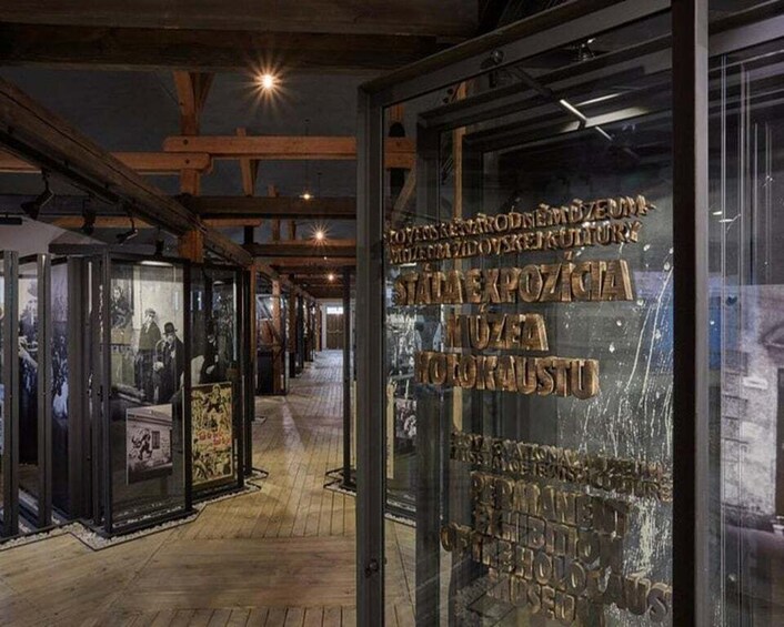 An indoor museum with glass display cases and wooden beams on the ceiling. 1