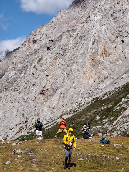 A group of hikers on a rocky mountain trail with a steep incline. 4
