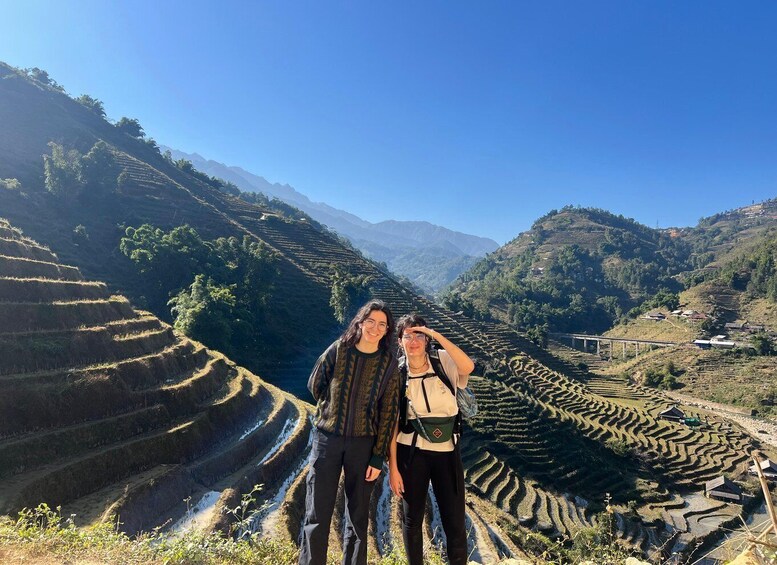 Terraced rice fields, a clear sky, and distant mountains. 5