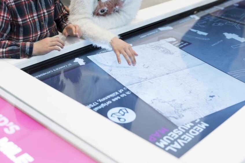 A person interacting with a digital map display. 3