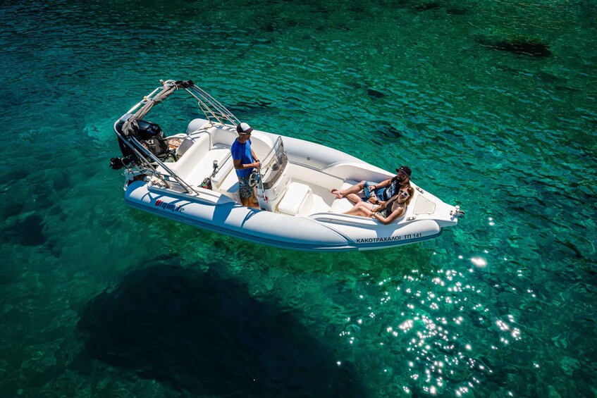 A small inflatable boat on clear turquoise water. 3