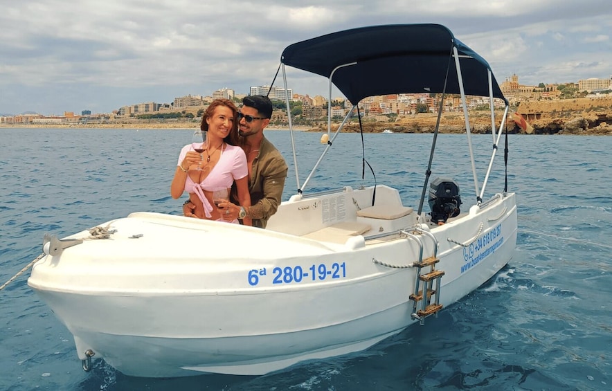 A white motorboat with a canopy, number 6a 280-19-21, on calm blue waters with a cityscape in the background. 1