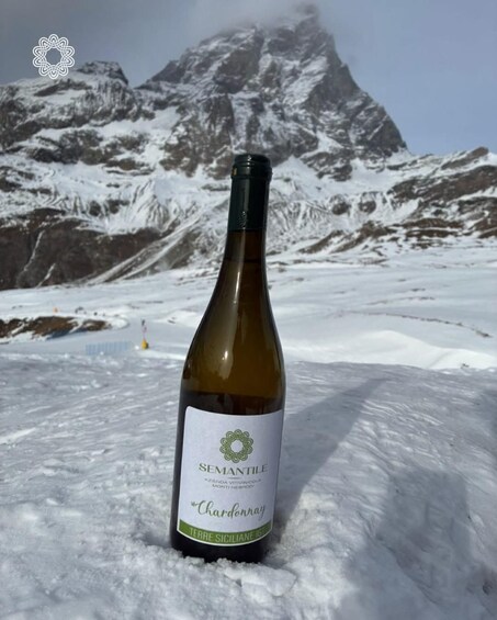 A bottle of Semantile Chardonnay on a snowy mountain. 5