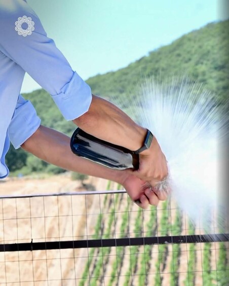 A person spraying water from a hose onto a field. 4