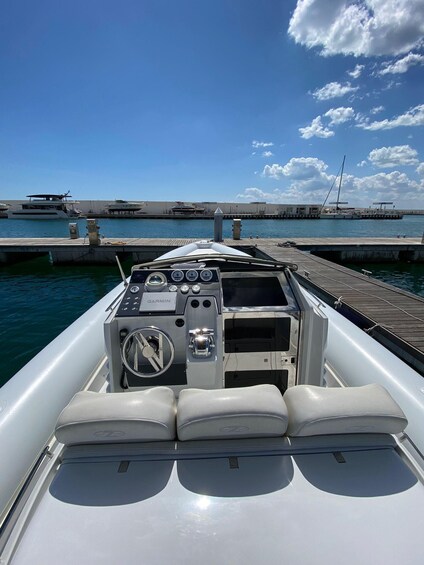 A boat's interior with a Garmin navigation system, a steering wheel, and seating. 3