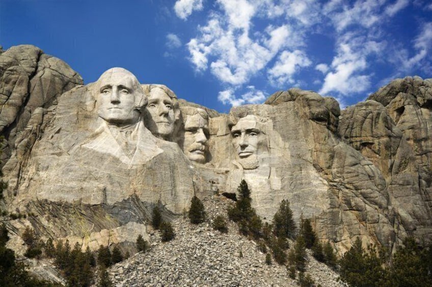 Mount Rushmore with four presidential faces carved into the rock. 5