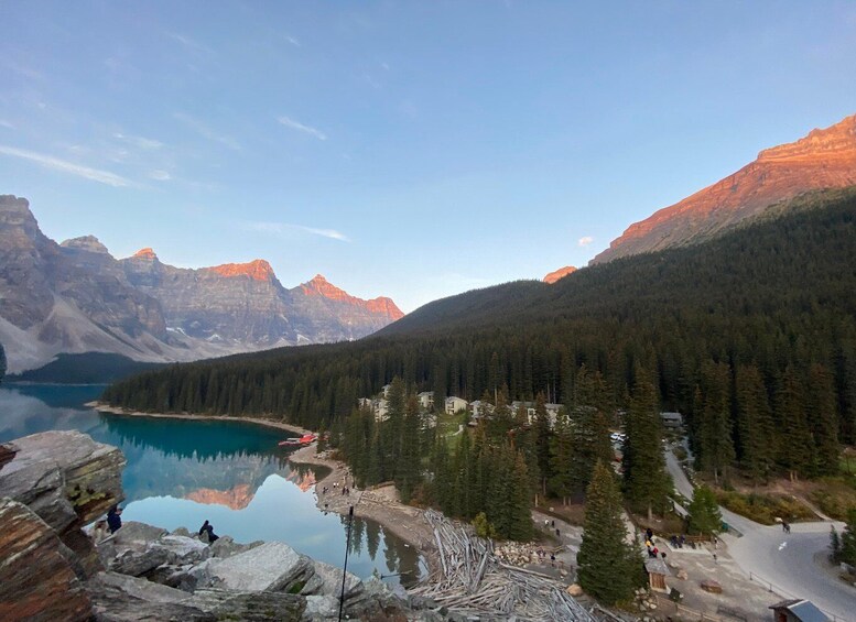 A mountain lake with forested slopes and a clear sky. 2