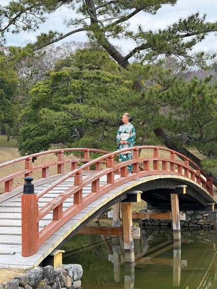 A wooden bridge with a person in traditional attire standing on it. 5
