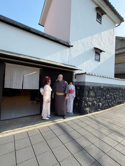 A building with a stone wall and a tiled entrance. 4