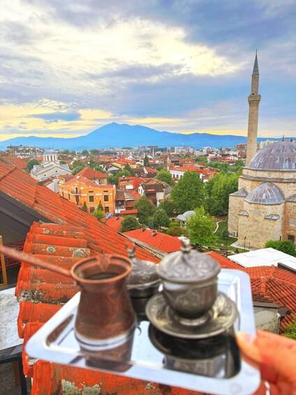 A cityscape with a prominent mosque and a mountain in the background. 5