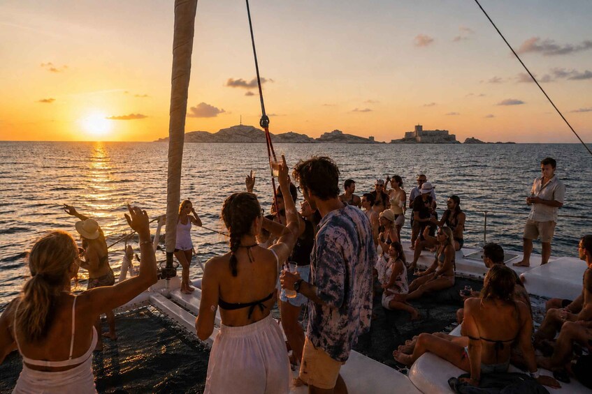 A group of people on a boat at sunset with the sun reflecting on the water. 3