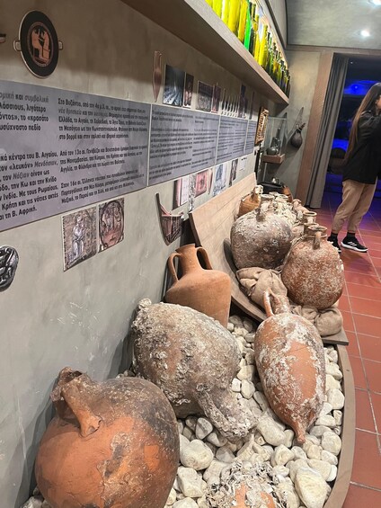 Ancient pottery displayed on a wall with accompanying text descriptions. 2