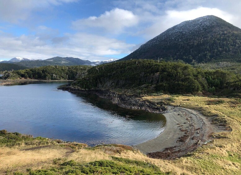 A lake surrounded by mountains and a beach. 5