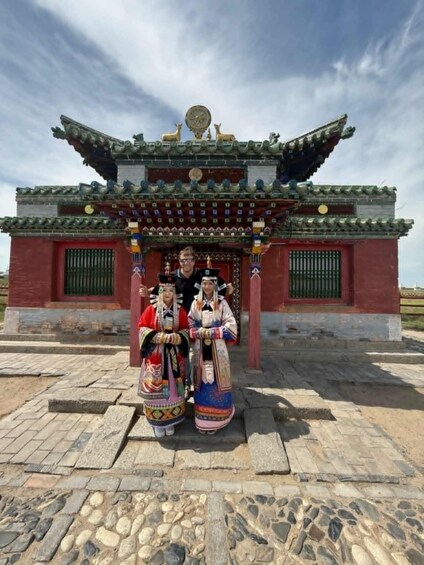 A traditional building with a tiled roof and a red facade. 1