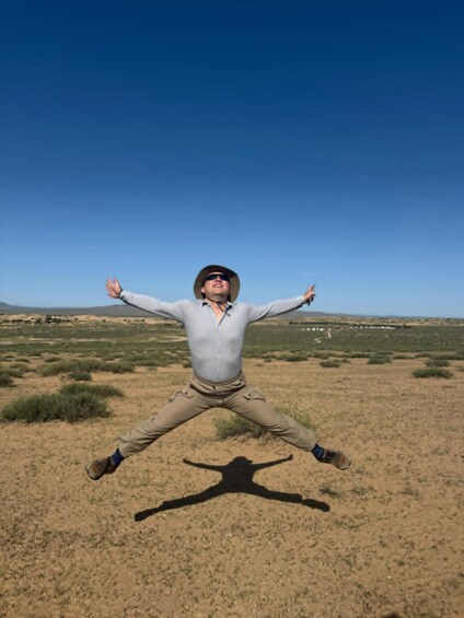 A person in a desert landscape with arms outstretched. 4