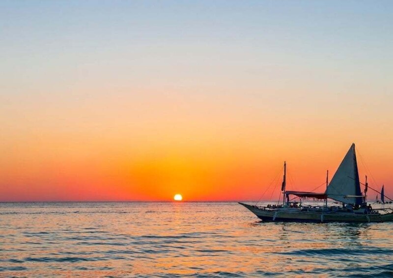 A boat with sails at sunset. 1