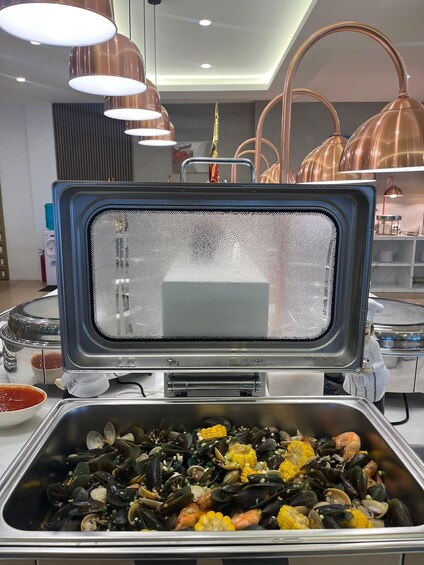 A buffet with seafood, including mussels and shrimp, and a grill station. 2