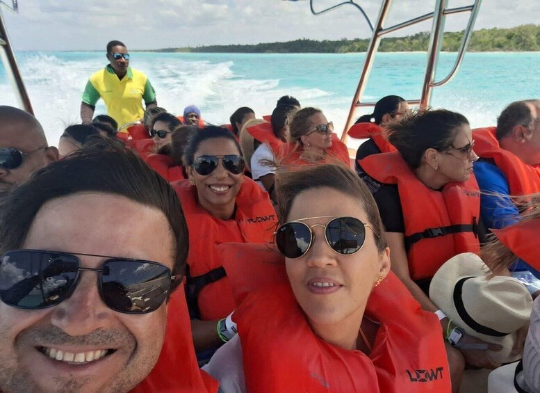 People on a boat wearing life jackets. 4