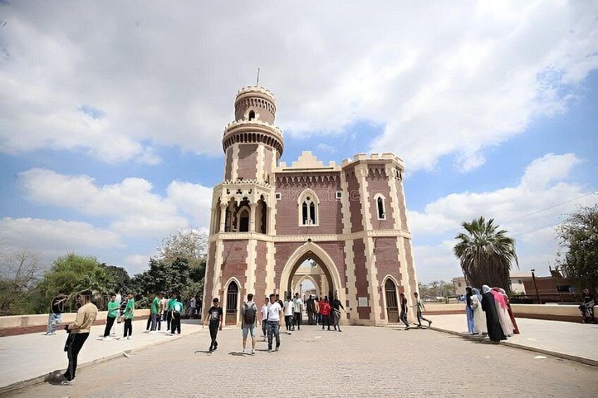 A historic building with a central archway and a tower. 3