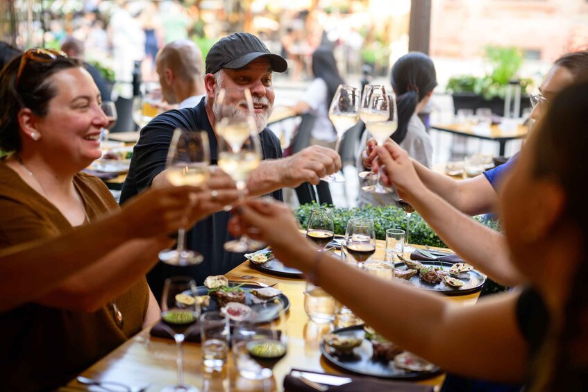 People toasting with wine glasses at a restaurant. 1